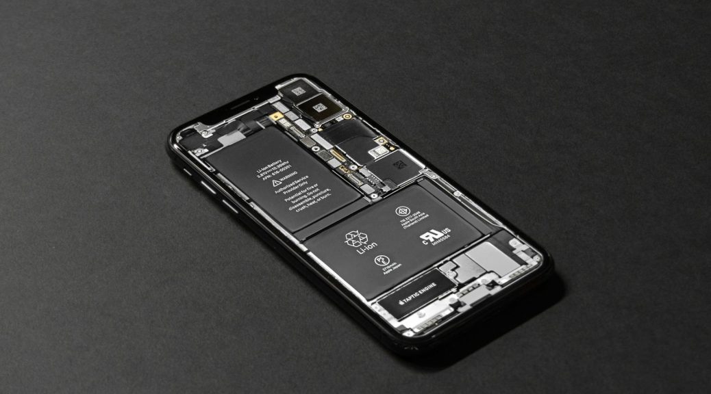 High-resolution image of a smartphone showcasing its internal components on a dark surface.